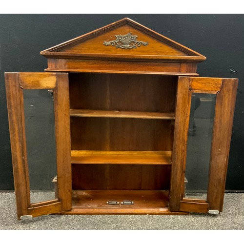 115 - A small mahogany wall hanging display/specimen cabinet, shaped pediment above two bevelled glass doo... 