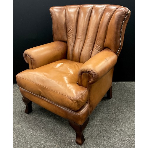 124 - A tan leather ‘Tetrad Blake’ type, ‘Barrel-back’ armchair, 101cm high x 83cm wide x 91cm deep.