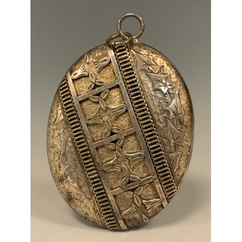 290 - A  large 19th century Aesthetic Movement silver coloured metal oval locket, embossed and relief deco... 