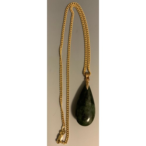 299 - A Chinese green stone possibly nephrite jade pear drop pendant necklace, unmarked yellow metal loop ... 