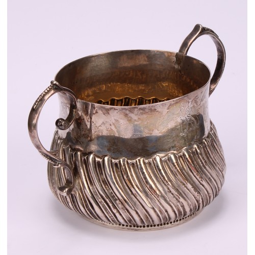 31 - A George III silver wrythen-fluted porringer, of 17th century design, 18cm over handles, London, 177... 