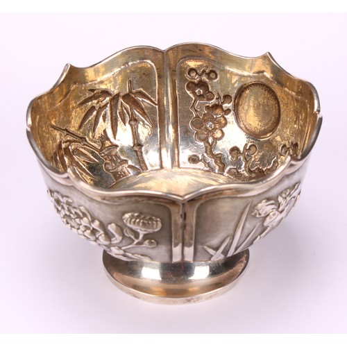 32 - A Chinese silver lotus shaped pedestal bowl, applied with panels of chrysanthemums, bamboo, irises a... 