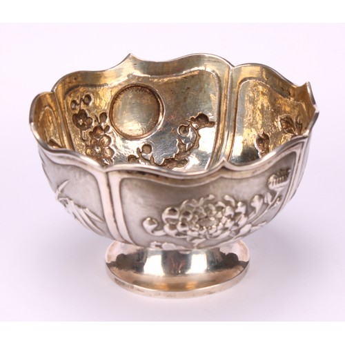 32 - A Chinese silver lotus shaped pedestal bowl, applied with panels of chrysanthemums, bamboo, irises a... 