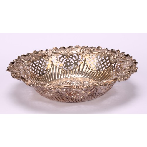 39 - A Victorian silver shaped circular sweetmeat dish, the field chased in bold relief with leaves and r... 