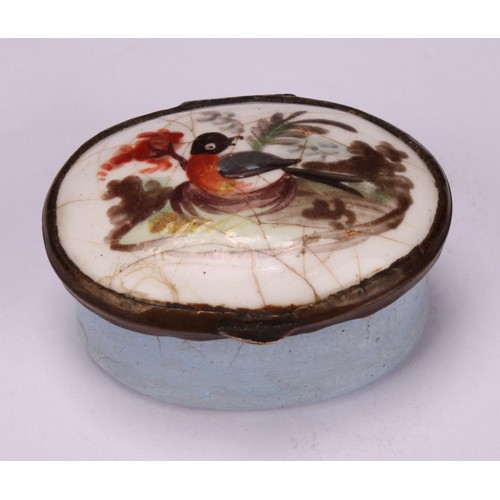 44 - A George III South Staffordshire enamel oval patch box, hinged cover painted with a bird, pale blue ... 