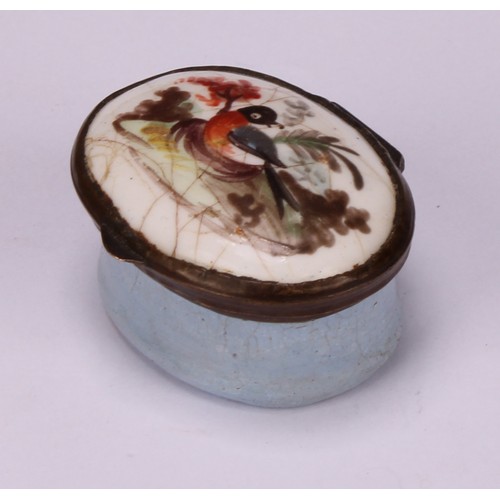 44 - A George III South Staffordshire enamel oval patch box, hinged cover painted with a bird, pale blue ... 