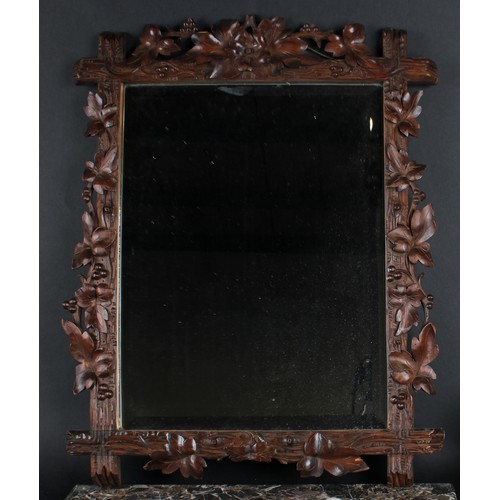 450 - A Black Forest rectangular looking glass, carved with fruiting vine, bevelled mirror plate, 75cm hig... 