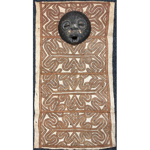 497 - Tribal Art - a Papua New Guinea Tapa type cloth; a circular wall mask, inlaid with metal and beads, ... 