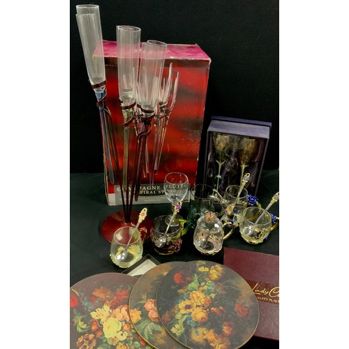 53 - A set of six Krasno Glass champagne flutes in spiral stand, and six spares, metal mount glass cups; ... 