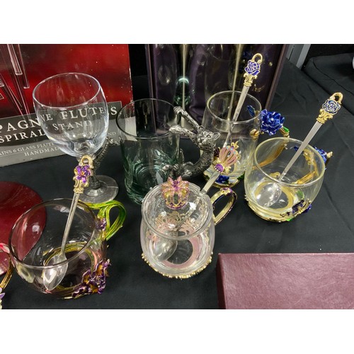 53 - A set of six Krasno Glass champagne flutes in spiral stand, and six spares, metal mount glass cups; ... 