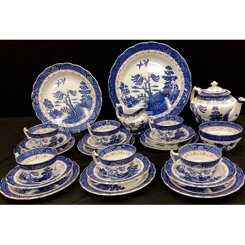 71 - A Booths Real Old Willow pattern six setting tea set inc teapot, large plate, cups saucers, side pla... 