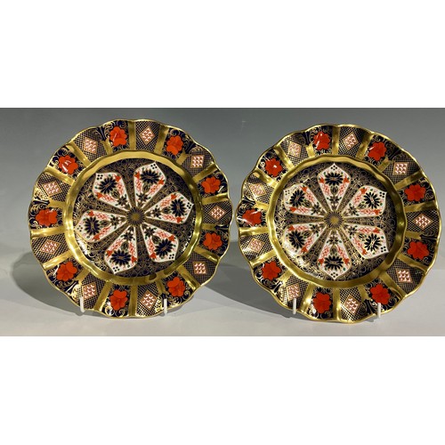 40 - A pair of Royal Crown Derby 1128 Old Imari pattern shaped circular plates, solid gold band, 22cm dia... 