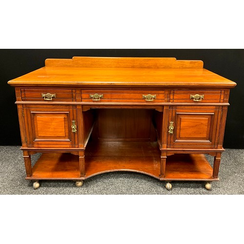 105 - An early 20th century mahogany desk, quarter galleried top, three drawers to frieze, above a pair of... 