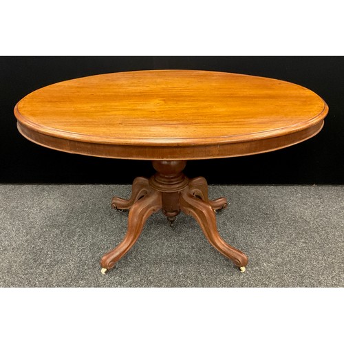 115 - A Late Victorian mahogany Loo Table, oval top tilt-top, turned pedestal base with four carved, scrol... 