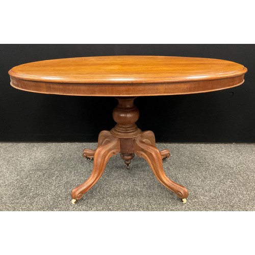 115 - A Late Victorian mahogany Loo Table, oval top tilt-top, turned pedestal base with four carved, scrol... 