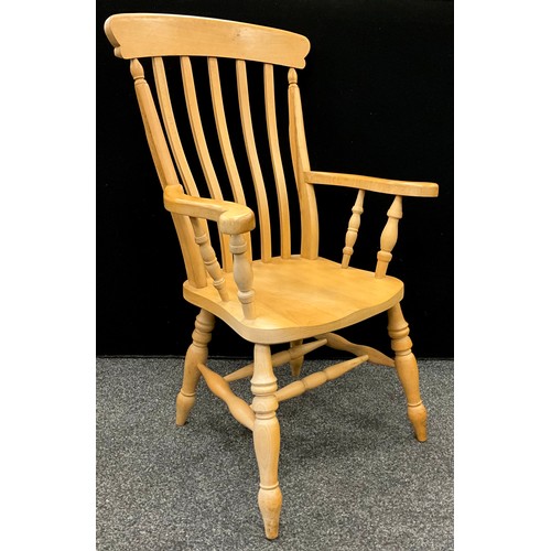 129 - A Victorian style lath back farm house kitchen armchair, 114cm high x 67.5cm wide.