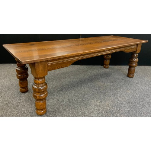 135 - A large oak plank top dining table, thick solid oak top, raised on broad turned legs, 76.5cm high x ... 