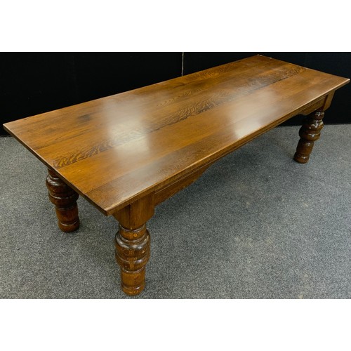 135 - A large oak plank top dining table, thick solid oak top, raised on broad turned legs, 76.5cm high x ... 