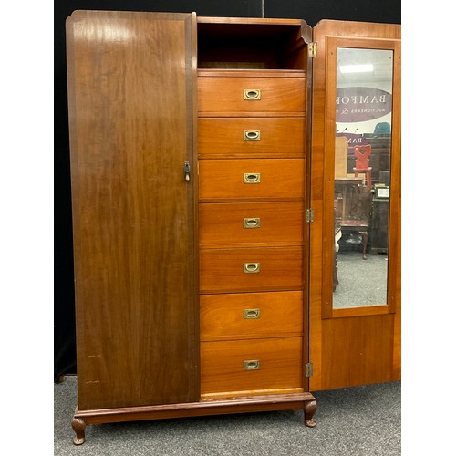 147 - A mid 20th century mahogany compactum double wardrobe, fitted interior to one side with seven gradua... 