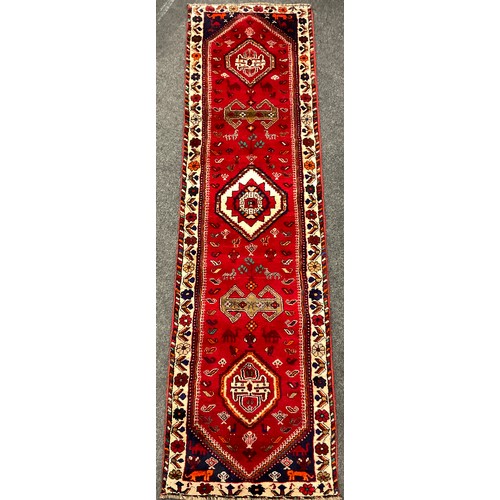 152 - A South-west Persian Qashgai runner carpet, hand-knotted in rich colours, with five medallions, with... 