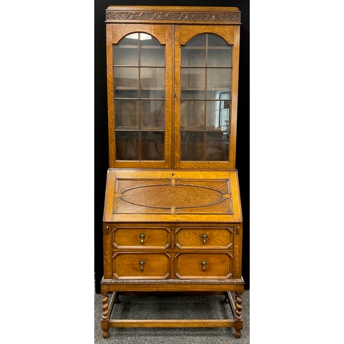 192 - An early 20th century oak bureau bookcase, 207cm high x 85.5cm wide x 44cm .