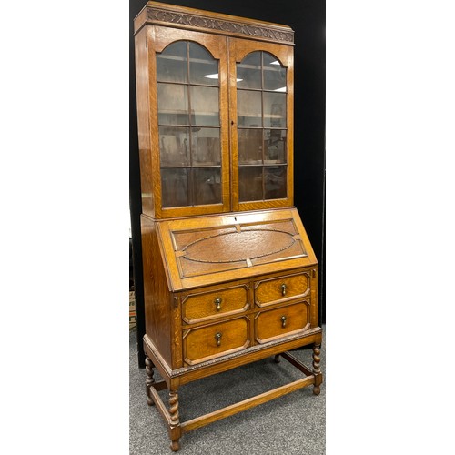 192 - An early 20th century oak bureau bookcase, 207cm high x 85.5cm wide x 44cm .