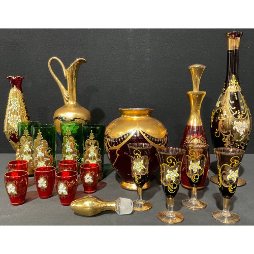 59 - Bohemian Glass - a red glass liquor set comprising decanter and six glasses; a pale blue glass ewer,... 