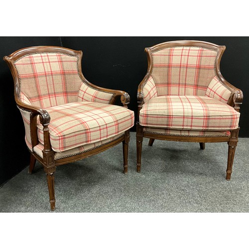 200 - A pair of tartan upholstered armchairs, serpentine shaped backs, with scroll arms, upholstered backs... 