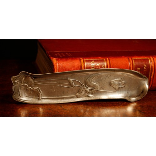 67 - An Art Nouveau polished pewter pen tray or dish, decorated in relief, indistinctly marked, 24cm long... 