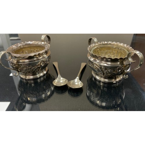 246 - A cased pair of Edwardian silver twin handled table salts, clear glass liners, Birmingham 1904, asso... 