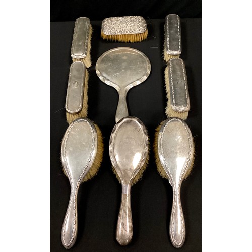 258 - A silver four piece dressing table brush set, marks worn, possibly Birmingham 1919;  other brushes, ... 