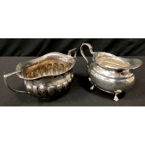 259 - A George V silver cream jug, Henry Wigfull, Sheffield 1919;  a gadrooned twin handle sugar bowl, Wil... 