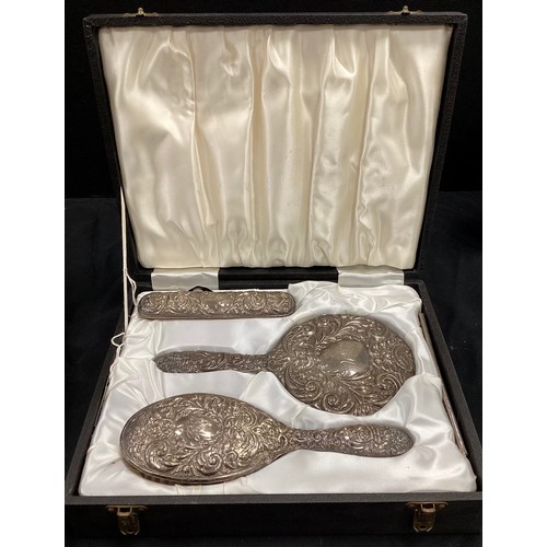 266 - An Elizabeth II silver three piece dressing table set, Birmingham 1972, cased.