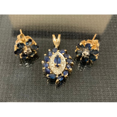 284 - A sapphire and diamond pendant, navette panel set with thirteen blue sapphires and ten round brillia... 