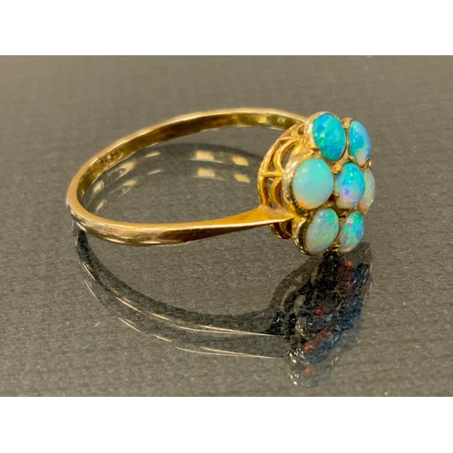 289 - An opal cluster ring,  seven blue green cabochon opals, 9ct gold shank, size O, 1.2g gross