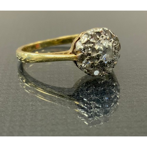 292 - A diamond cluster ring, set with nine round brilliant cut diamonds , yellow metal shank, stamped 18c... 