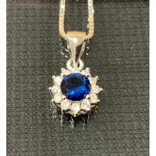 294 - A blue and white cubic zirconia pendant necklace, 925 silver mount box link chain, 3g gross.