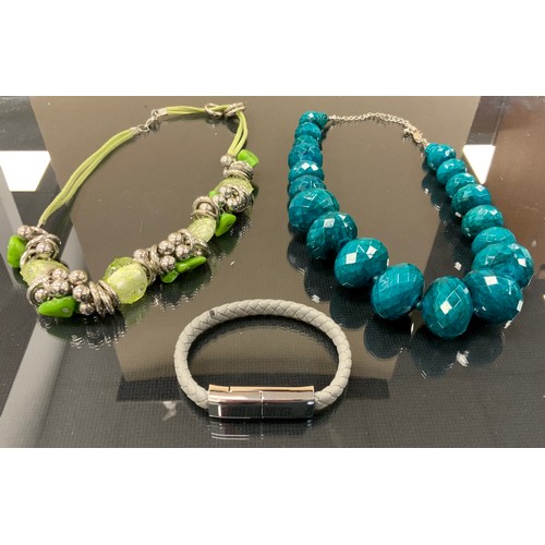 297 - Jewellery - a plaited grey leather bracelet, USB style clasp;  two bead necklaces in tones of green,... 