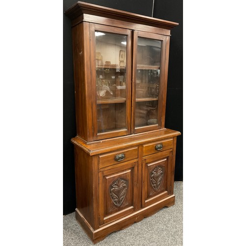 150A - A late Victorian mahogany bookcase cabinet, out-swept cornice, above pair of glazed doors enclosing ... 