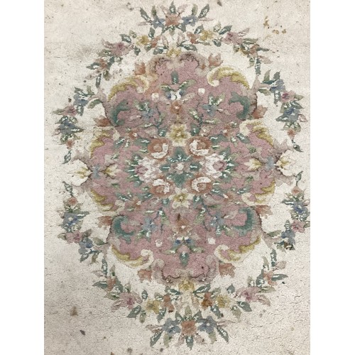 162A - A large Chinese woven wool rug,in tones of pink, cream and green, 284cm x 225cm; another 350cm x 251... 