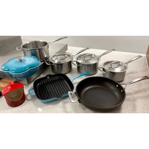 165 - Cookery and Kitchen equipment - Le Creuset - three stainless steel lidded saucepans, single sauce pa... 