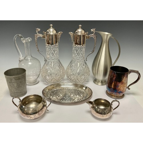 131 - Silver Plate & Glass - A pair of cut glass claret jugs mounted with EPNS collar and lid, C-scroll ha... 