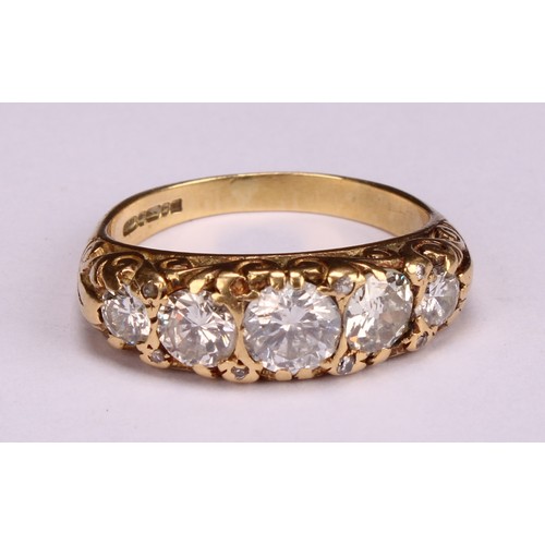 166 - An 18ct gold five stone diamond ring, the graduated stones interspersed with diamond chips, estimate... 