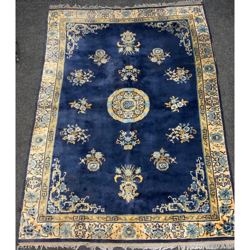 111 - A Chinese silk and wool mix rug, central floral medallion within blue ground, stepped floral borders... 