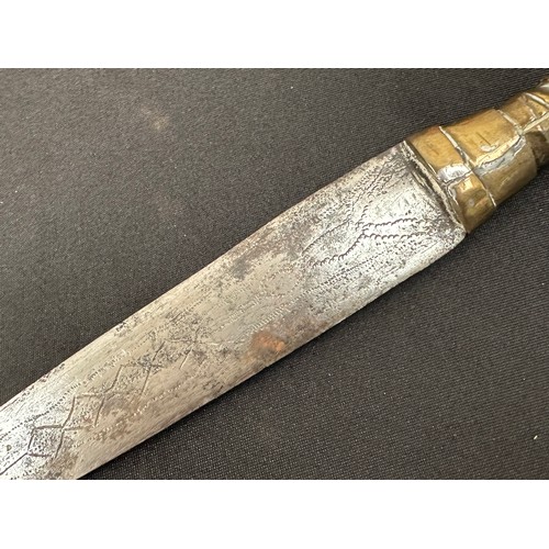 2075 - Dagger with double edged blade 260 mm in length. Blade decorated with punch mark patterns. Brass gri... 