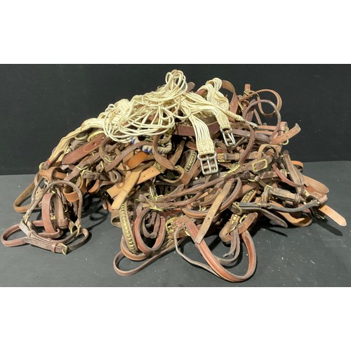 405 - Equestrian Interest - a quantity of leather and brass horse bridles; others, bits, straps, etc, qty