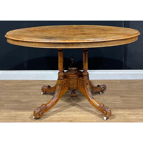 91 - A Victorian walnut oval centre table, tilting top, 72cm high, 119.5cm long, 89cm wide, c.1870