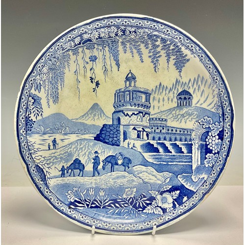 509 - A 19th century Staffordshire transfer printed blue and white cheese dish base, printed with ruins an... 