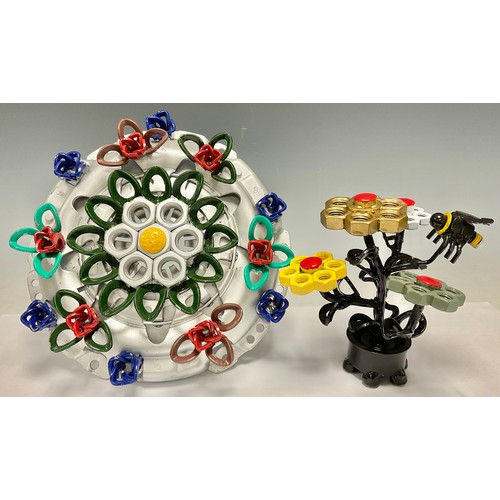 516 - Steam Punk - a sculptural table centre as a vase of flowers, constructed from car parts, nuts and bo... 