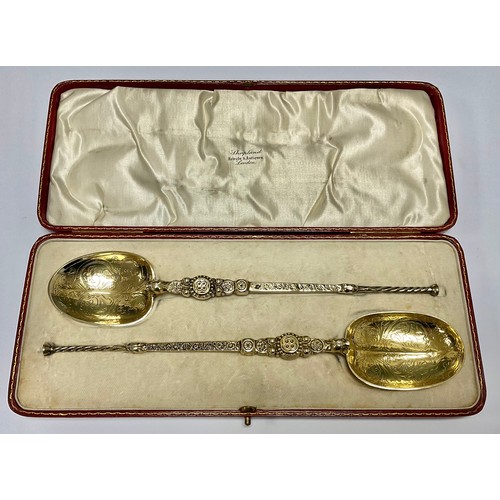 546 - A matched pair of silver gilt anointing spoons, Cornelious Desormeaux & James Francis Hollings, Lond... 